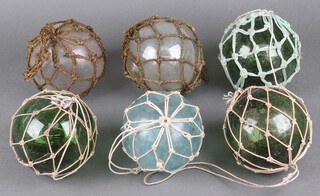 Twenty one various 19th Century clear glass fishing floats/buoys,  (3 clear and 18 green glass), contained in a fruit box 