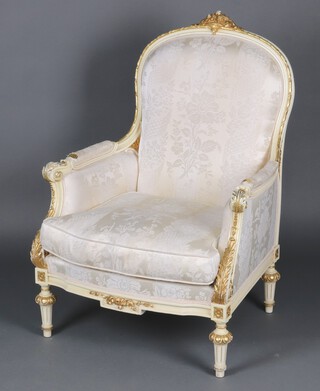 A Louis style white and gilt painted armchair raised on turned and fluted supports (damage to arms, stains to seat and back) 