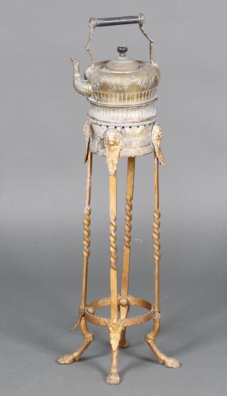 A 19th Century embossed brass tea kettle raised on a circular stand 