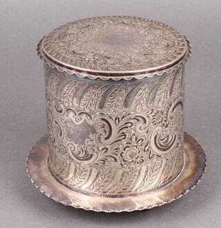 A James Dixon & Sons cylindrical embossed silver plated biscuit barrel with hinged lid, raised on bun feet 15cm  
