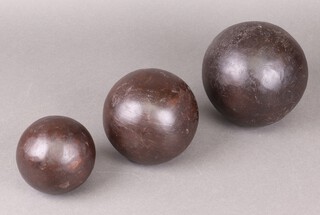 A turned wooden sphere 14cm and 2 small ditto 