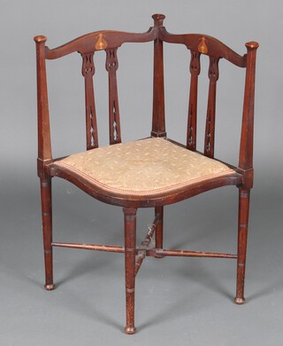 An Edwardian Art Nouveau inlaid mahogany corner chair raised on turned supports 