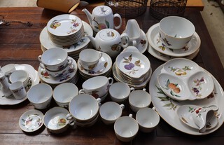 A collection of Royal Worcester Evesham Gold pattern dinner ware comprising platter, oval dish, meat plate, bowl, 3 section dish, sauce boat and stand, 8 Grattan dishes, coffee pot, teapot, small sauce boat and stand, 7 dinner plates, 8 tea plates, 6 tea cups, 6 saucers, 6 twin handled soup bowls and 6 saucers (1 chipped), etc 