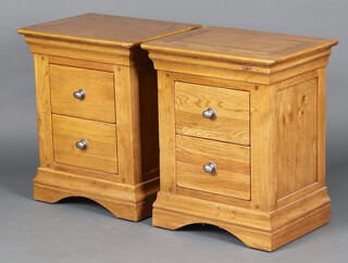 A pair of light oak bedside cabinets, each fitted 2 drawers, 64cm h x 53cm w x 40cm d 