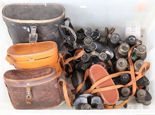 A large quantity of antique and later binoculars together with a coaching lamp