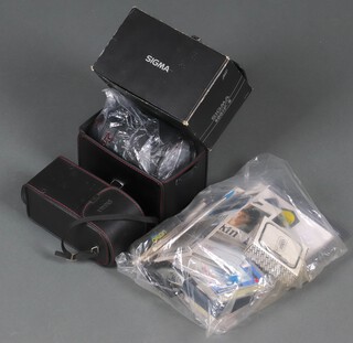 A cased Sigma  600mm F/8 telephoto lens for the Minolta (boxed and with hard case), together with an unassociated empty Sigma hard case and a collection of Konkin and other filters 