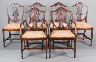 A set of 6 20th Century Hepplewhite style shield shaped camel back dining chairs with upholstered drop in seats - 2 carvers 95cm h x 52cm w x 43cm d, 4 standard, raised on square tapered supports 