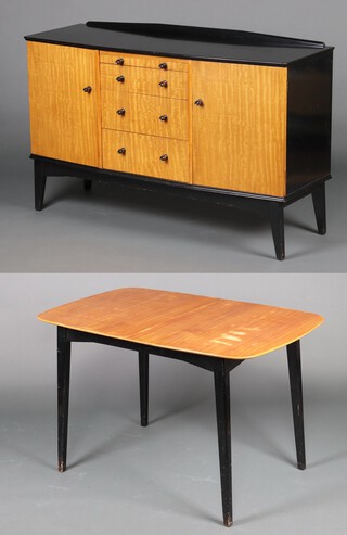 A mid-century teak and ebonised dining suite comprising sideboard with raised back, brushing slide above 3 drawers, flanked by pair of cupboards 85cm h x 129cm w x 47cm d together with a matching dining table with 1 extra leaf 76cm h x 75cm w x 122cm l (sun bleached  to top of table, contact marks in places)