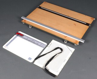 A draftsman's table top drawing board, the reverse marked British Thornton inspected no.6 93cm h x 65cm w, together with a plastic rotating college board 37cm x 49cm, a D.E. Products Board 34cm x 47cm 