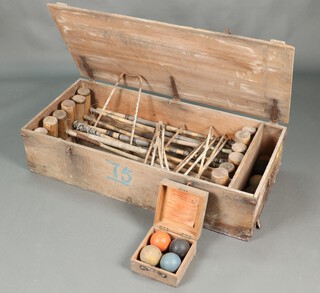 A Croquet set by F H Ayers (formerly the property of the Viscount of Buxton) with 4 Jacques croquet balls, contained in an Ayres wooden box, 6 other croquet balls, 7 iron croquet hoops (misshapen) and 12 various mallets (all requiring attention), contained in a pine trunk 30cm h x 122cm w x 57cm d (signs of old but treated worm to case)