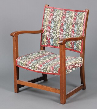 A 1930's oak framed open arm chair, the seat and back upholstered in tapestry material 69cm h x 53cm w x 41cm d 