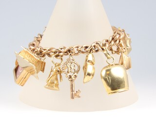 A 9ct gold charm bracelet with padlock clasp, hung 17 various charms, 16cm, gross weight 60 grams