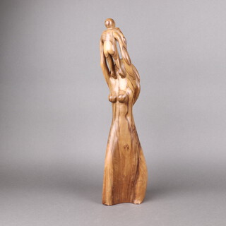 Colin Miller 1943, a carved yew figure in the form of a mother and child, 54cm h