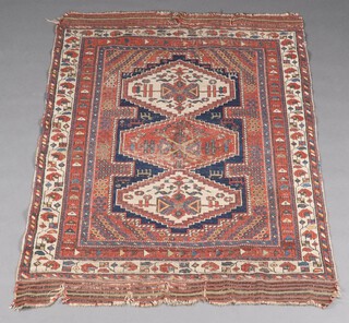 A blue, red and white ground Caucasian rug with 3 diamond shaped stylised medallions to the centre, within a multi row border 164cm x 123cm  