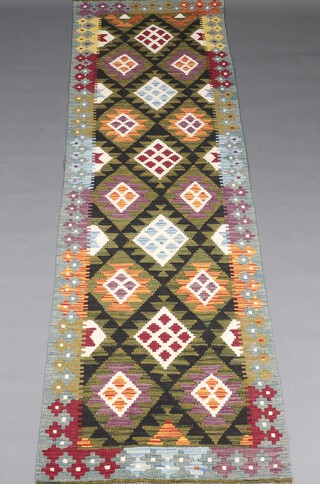 A green, white, brown and orange ground Maimana Kilim runner with all-over diamond design 290cm x 81cm 