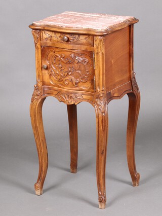 A French carved walnut bedside cabinet of serpentine outline and pink veined marble top, fitted a drawer above cupboard enclosed by a panelled door, raised on cabriole supports 83cm h x 43cm w x 37cm d 