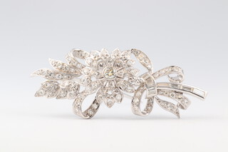 A white gold testing as 18ct diamond set floral spray brooch 5cm x 2cm, gross weight 9.4g
