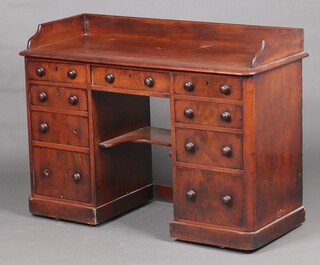 A Victorian kneehole pedestal dressing table with 3/4 gallery, the pedestal fitted a shaped drawer above 1 long and 5 short drawers, 1 pedestal enclosed by a panelled door 86cm h x 121cm w x 50cm d 