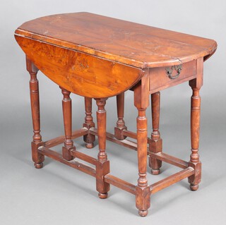 An 18th Century yew drop flap gateleg tea table fitted a frieze drawer with pierced brass plate drop handle, raised on turned supports with bun feet and square moulded stretcher, 76 cm h  106cm w x 45cm when closed x 91cm h when open 
