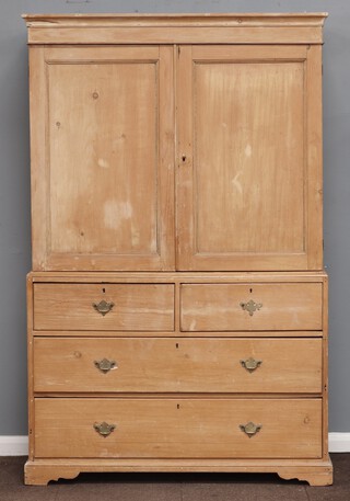 A Victorian pine linen press with moulded cornice, the interior fitted shelves enclosed by panelled doors, the base fitted 2 short and 2 long drawers with swan neck drop handles, raised on bracket feet 192cm h x 124cm w x 51cm d 