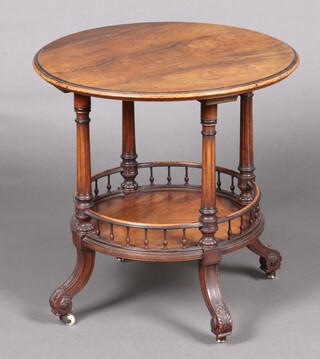 A Victorian circular walnut 2 tier occasional table with bobbin turned decoration, raised on outswept supports with ceramic casters 60cm h x 60cm diam. 
