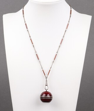 A Swiss silver and red enamelled ball pendant watch hung on an enamelled and white metal link chain, 72cm