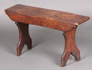 A 17th Century style rectangular oak stool, raised on panelled supports 41cm h x 75cm w x 21cm d 