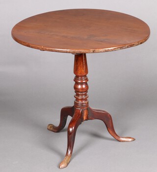 A 19th Century circular mahogany snap top mahogany tea table, raised on a pillar and tripod base 70cm h x 76cm diam. 