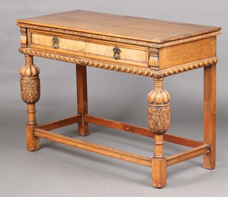 Beresford & Hicks, London, a 1920's Continental style carved oak side/serving table, fitted 2 frieze drawers, raised on cup and cover supports with box framed stretcher 85cm h x 118cm w x 53cm d 