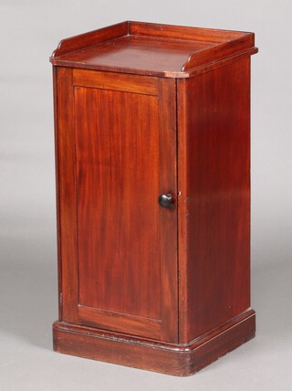A Victorian mahogany pot cupboard with 3/4 gallery enclosed by panelled doors, raised on a platform base 80cm high x 40cm w x 36cm d 