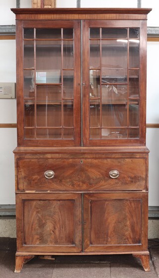 A Georgian mahogany secretaire bookcase the upper section with moulded cornice fitted adjustable shelves enclosed by astragal glazed panelled doors, the base fitted a secretaire drawer with pigeon holes and drawers above 1 long and 2 short drawers enclosed by a pair of panelled doors, raised on bracket feet 228cm h x 117cm w x 56cm d 