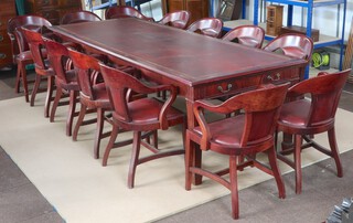 A Victorian style mahogany board room / dining suite comprising rectangular meeting table with inset writing surface, fitted a drawer, raised on square tapered supports ending in spade feet 78cm h x 274cm l x 106 cm w, together with 13 tub back chairs with upholstered seats and backs in red material, raised on square supports with H framed stretchers 87cm h x 52cm w x 41cm d (seats 27cm x 27cm)