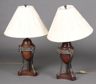 An impressive pair of Adam style turned mahogany urn shaped table lamps on metal rams head and hoof supports with triform base 41cm h x 21cm 