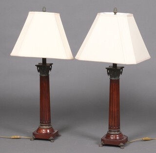 An impressive pair of turned and fluted mahogany table lamps with swan neck column capitals 47cm h x 14cm 