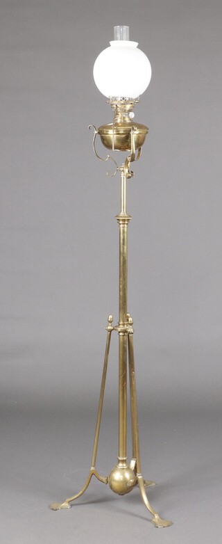A brass standard oil lamp with reservoir marked Naple, with clear glass chimney and opaque glass shade, converted to electricity 169cm h 