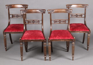 A set of 4 19th Century carved mahogany bar back dining chairs with upholstered drop in seats, raised on turned and reeded supports  