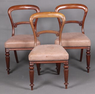 A set of 3 Victorian bleached mahogany spoon back dining chairs with carved mid rails, seats upholstered in light brown leather on reeded supports