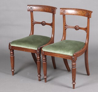 A pair of 19th Century carved mahogany bar back dining chairs with drop in seats, raised on turned and reeded supports 