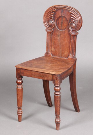 A 19th Century mahogany hall chair with ionic column decoration to the side, solid seat, raised on turned supports 