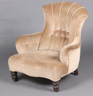 A Victorian mahogany tub back chair upholstered in mushroom coloured material, raised on turned supports 