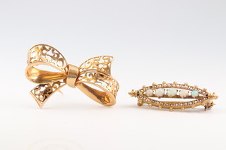A yellow metal bow shaped brooch 4cm, 5.5g and a gilt metal brooch set demi-pearls and opals
