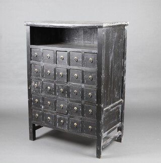A 19th Century Chinese ebonised medicine chest with recess above 25 drawers each with ring drop handles 128cm h x 91cm w x 54cm d 