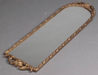 A 1950's arched plate mirror contained in a decorative gilt painted plaster frame 106cm x 33cm 