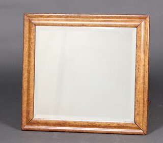 A rectangular bevelled plate mirror contained in a maple frame 57cm x 62cm 