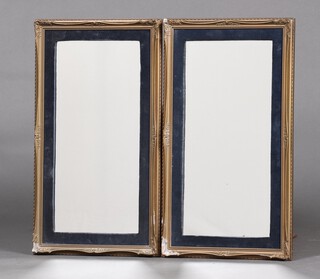 A pair of rectangular plate mirrors contained in gilt plaster and blue plush frames 59cm x 42cm 