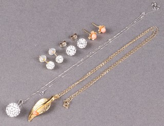 A 9ct white gold and brilliant set necklace and earrings, a 9ct yellow gold necklace with gilt pendant, a pair of coral set yellow metal earrings