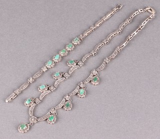 A Continental filigree silver necklace set marcasite and green stones together with a matching bracelet, in a fitted case 