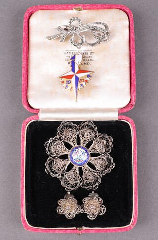 An Indian pierced filigree brooch with enamelled panel to the centre decorated birds, 2 matching earrings, a Festival of Britain brooch and 1 other brooch 