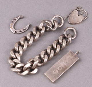 A silver curb link bracelet 18cm, a silver ingot pendant and a silver charm in the form of a horseshoe, 133g 