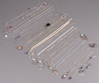 A silver pendant hung on a silver chain, together with a collection of costume jewellery